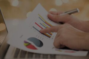 Business owner reviewing financial information and business valuation graphs