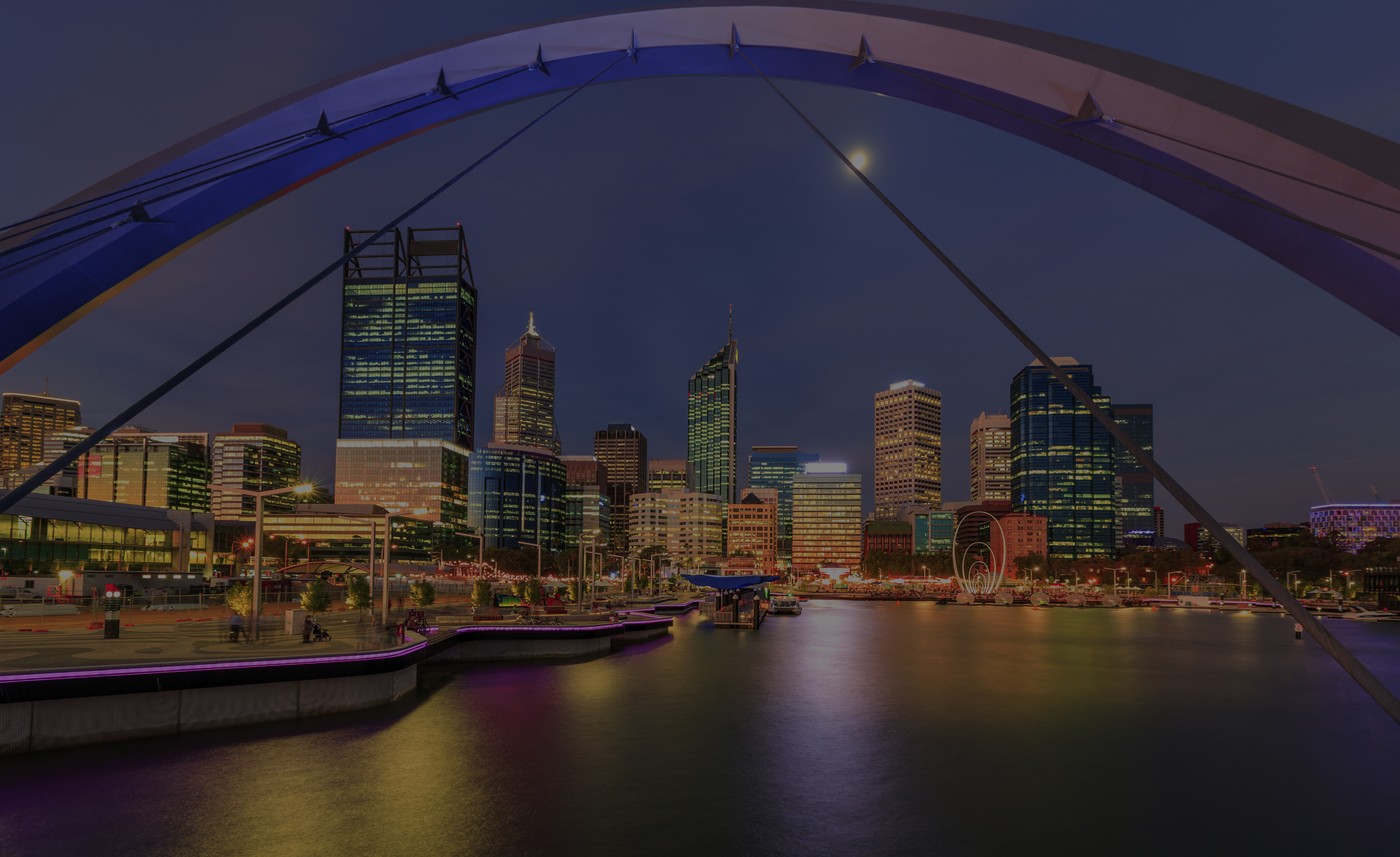 Long exposure of Elizabeth Quay Perth Western Australia just after sunset with the moon in the sky.